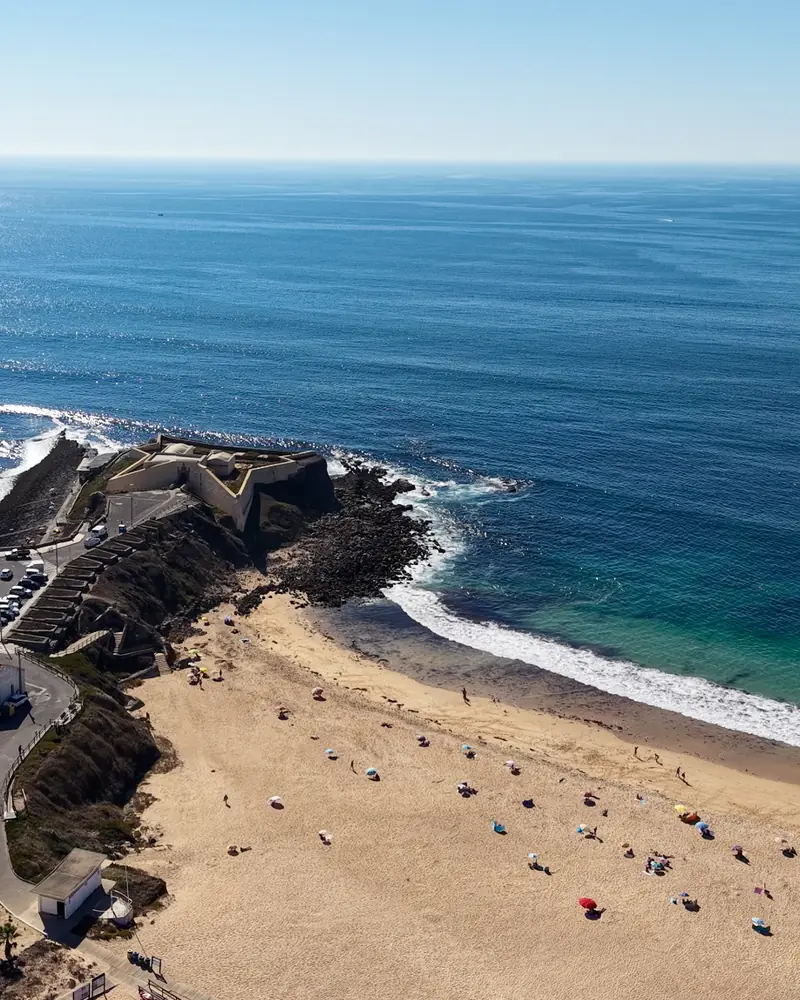 Praia da Consolação vista do ar, com o forte, a areia e o mar.