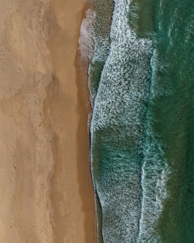 Ondas a rebentar no areal, vistas de cima.